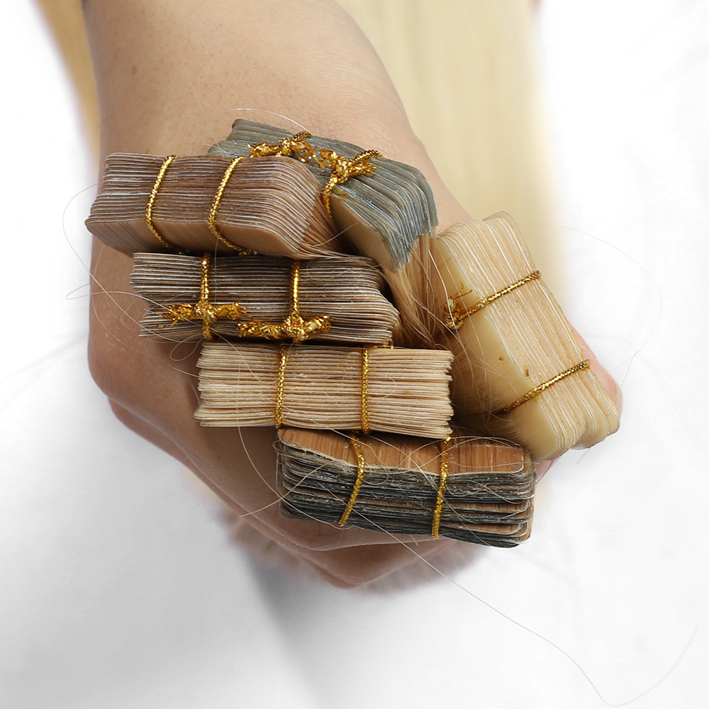 Angelbella Vendedor Venta al por mayor Extensiones de cinta rubia Cabello humano real Extensiones de cabello invisibles Cinta en Extensiones de cabello con cinta de trama de piel de PU rubia platino Cabello real para mujeres 8-32 pulgadas